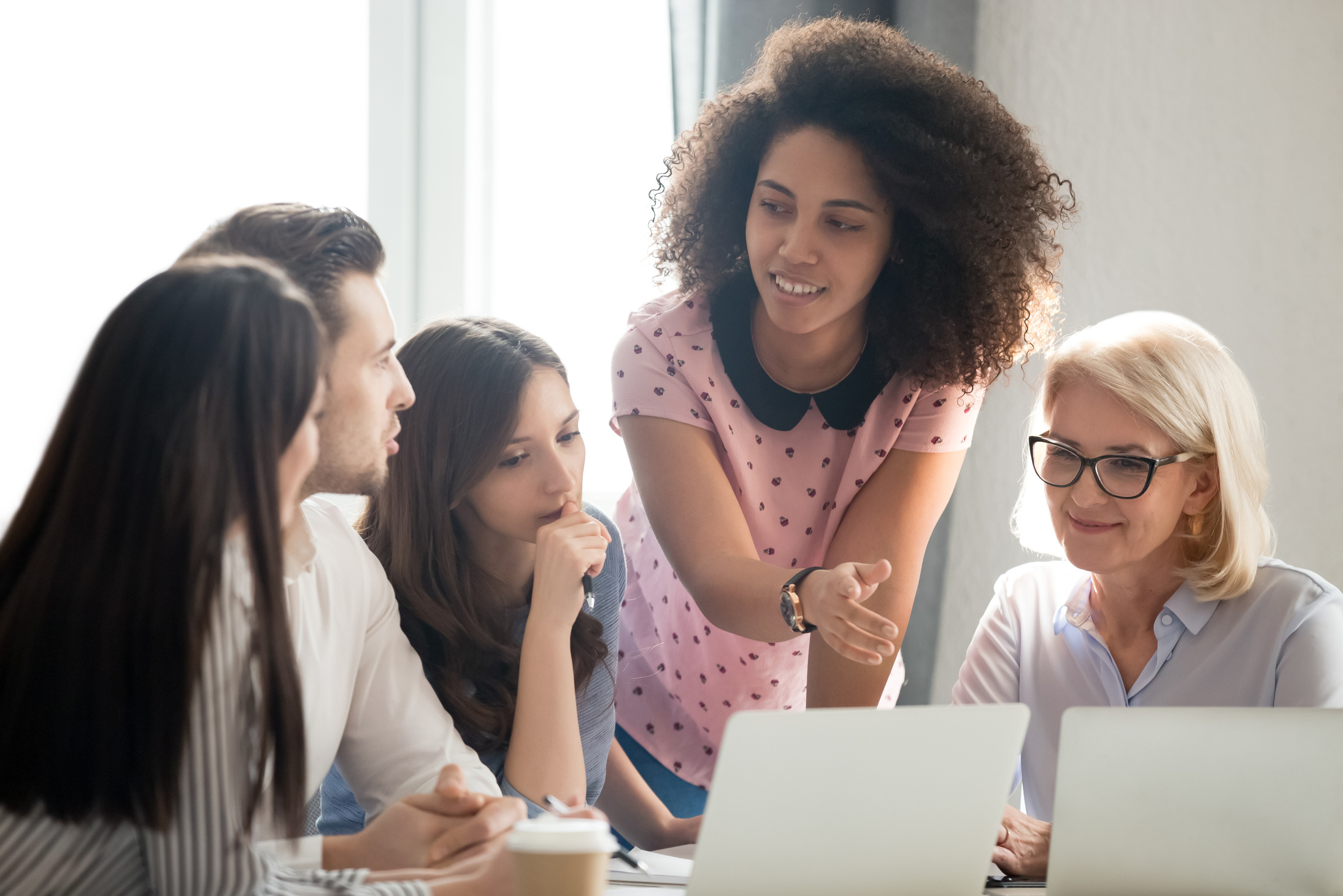 Diverse students workers team and mentor teacher involved in discussion